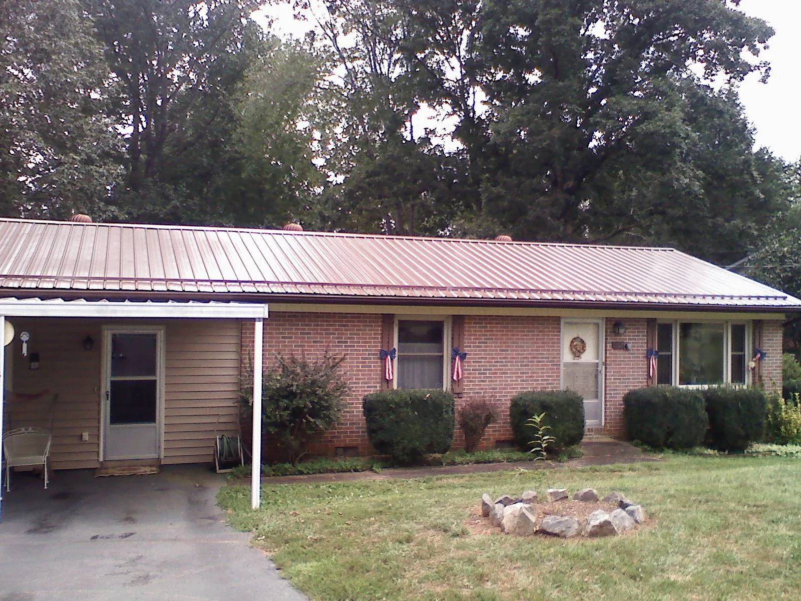 Bronze metal roof and carport on a brick ranch home — Roof Repair work by our crew in Calimesa